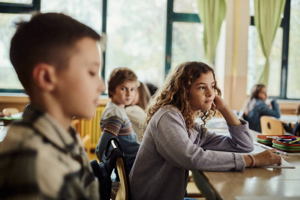 istock Bored schoolgirl on a class at elementary school. 1478342264