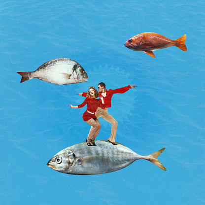 Art collage of stunning couple, man and woman wearing retro clothes and dancing on huge fish. Contemporary artwork. Surrealism, dancing, disco party, weekend, holiday, retro, vintage, art, ad concept