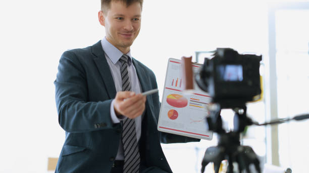 istock Businessman coach showing documents with graphs to camera 1478347249