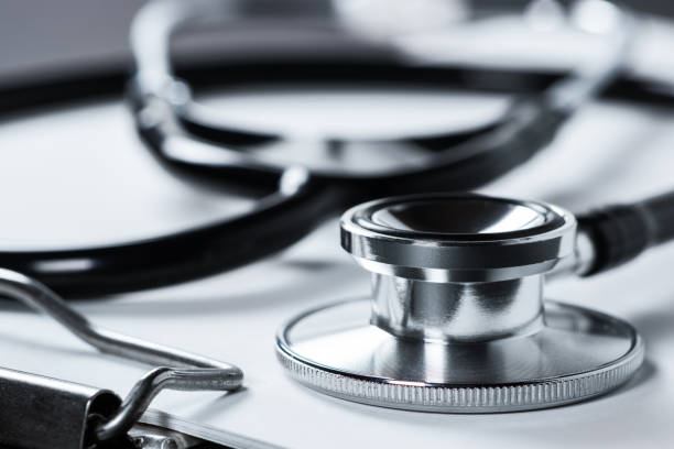 istock A stethoscope with white paper on it, set against a dark background 1478347354