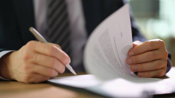 istock Businessman in suit signing document at work in office closeup 1478348483