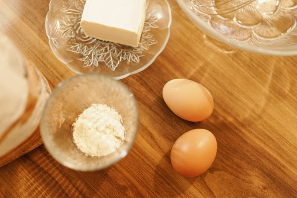 Close-up shot of making cookies. Detail shot of eggs, flour and margarine. Sunset concept, warm tones.