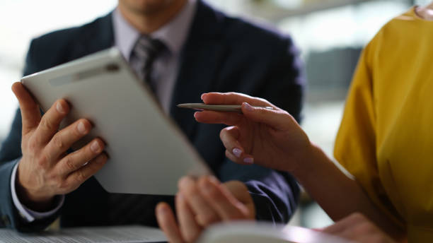 istock Business colleagues studying information on digital tablet in office closeup 1478349073