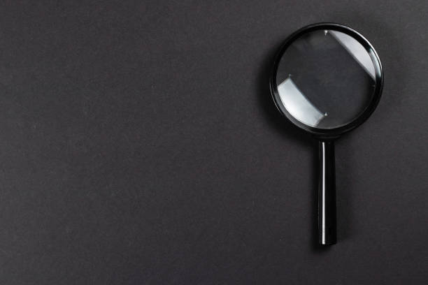 istock Magnifying glass or lens on dark, top view. 1478349221