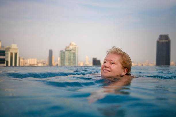 istock Active senior woman is swimming in pool 1478349789