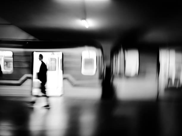 istock Black and white motion blur image of subway with a train and passengers. 1478349886