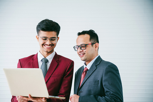 Father and son working together in home office