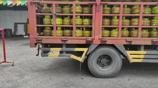 Photo of The supply of LPG or Liquid Petroleum Gas on red old dusty truck