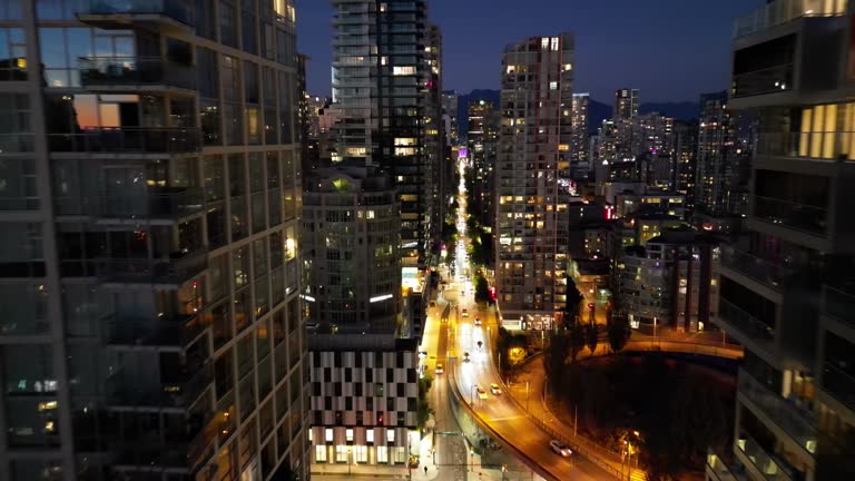 Drone view of illuminated Vancouver skyline with Granville Street Bridge at night in Canada