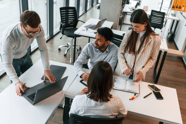 istock Conception of teamwork. Four people are in the office together 1478356589