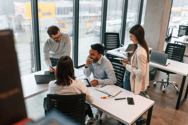 istock Conception of teamwork. Four people are in the office together 1478356628