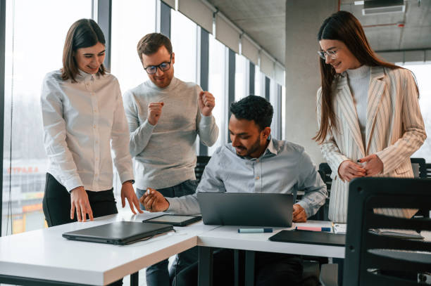 istock Having the meeting. Four people are working in the office together 1478357111
