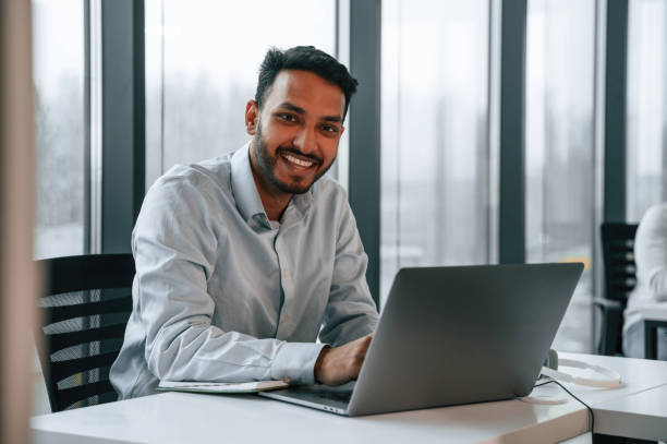 istock Beautiful indian man is working in the office by laptop 1478358505