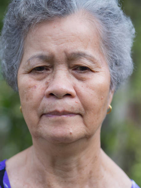 istock Senior woman anxious face while standing in a garden. 1478359743