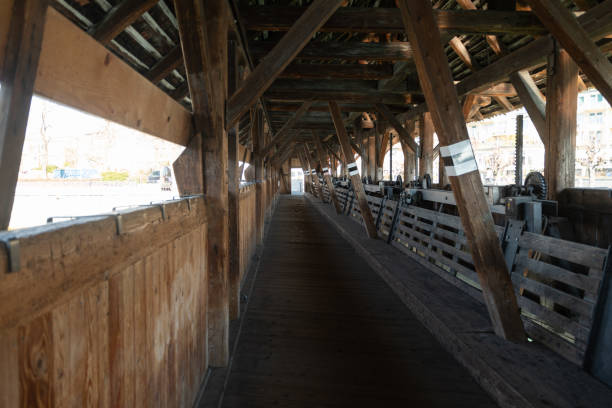 Thun, Switzerland, February 13, 2023 Historic old wooden bridge and pedestrian way in the city center