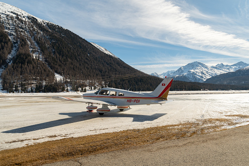 Samedan, Switzerland, February 21, 2023 Piper PA-28-181 Archer II is parking on the field