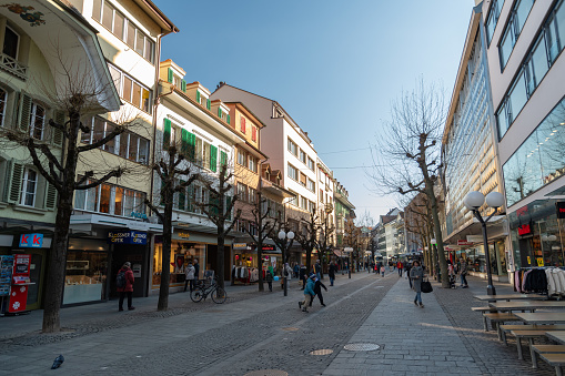 Thun, Switzerland, February 13, 2023 Popular shopping street in the city center on a sunny day