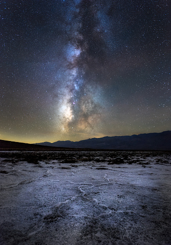 A vertical shot of the Badwater Basin under a starry sky at night in California, the US