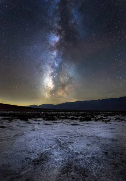 A vertical shot of the Badwater Basin under a starry sky at night in California, the US