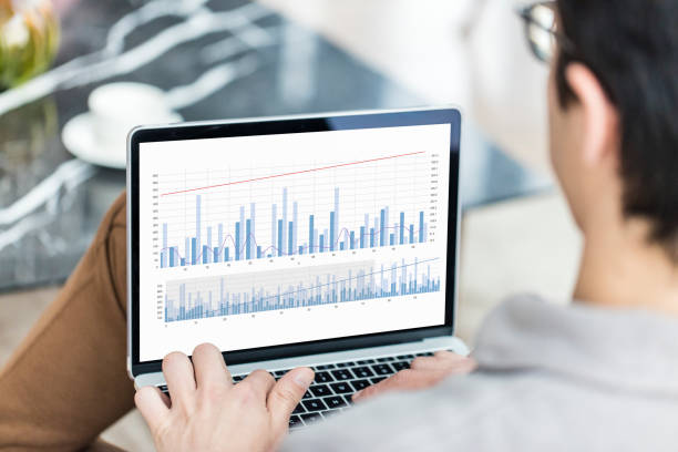 istock Young man looking Financial Charts on laptop 1478364251