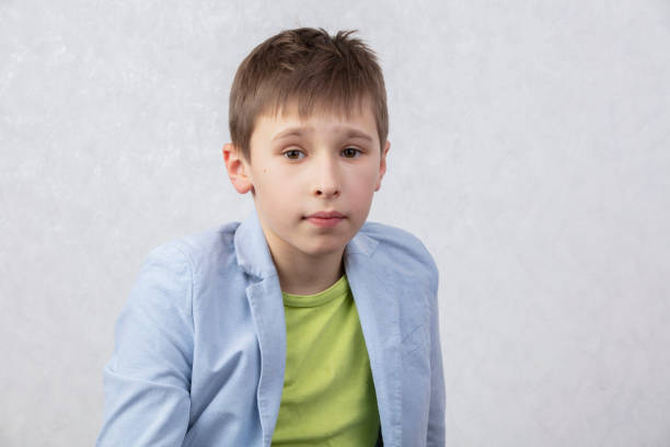 portrait of a boy of middle school age in a jacket. the child is ten years old. - 10 11 years cheerful happiness fun imagens e fotografias de stock