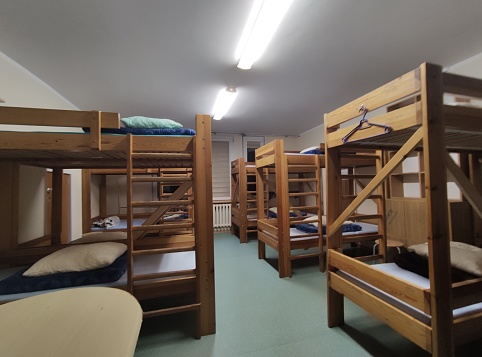 Cheap hostel room with a wooden bunk beds