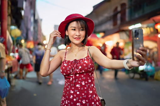 thai woman taking selfie in yaowarat chinatown bangkok thailand on street