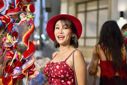thai woman posing with paper dragon toys on street in chinatown bangkok thailand during chinese new year