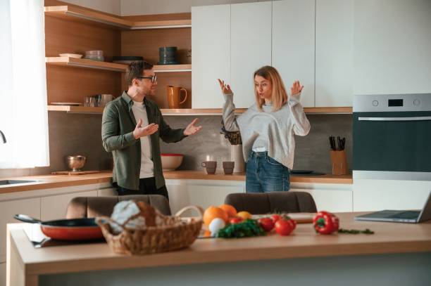 istock Shouting at each other, quarrel. Young couple is on the kitchen together 1478369660