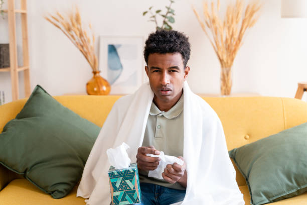 istock Black man cold blowing the nose 1478369695