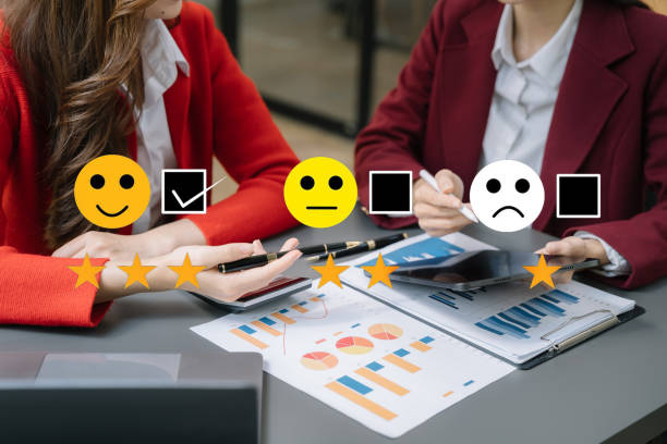 istock Asian Team woman holding a digital tablet with checkboxes rating smiley faces excellent for Satisfaction Survey, Happy Client Customer Experience concept. 1478372816