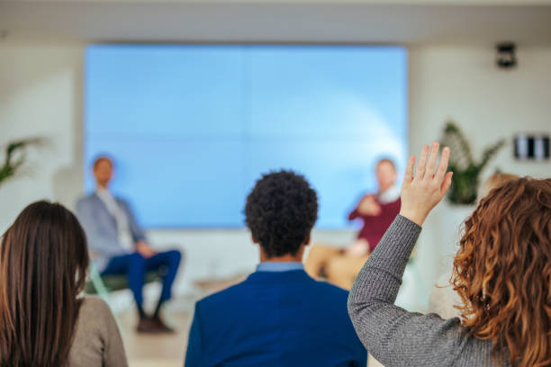 istock Woman raising hand for question at conference. 1478372881
