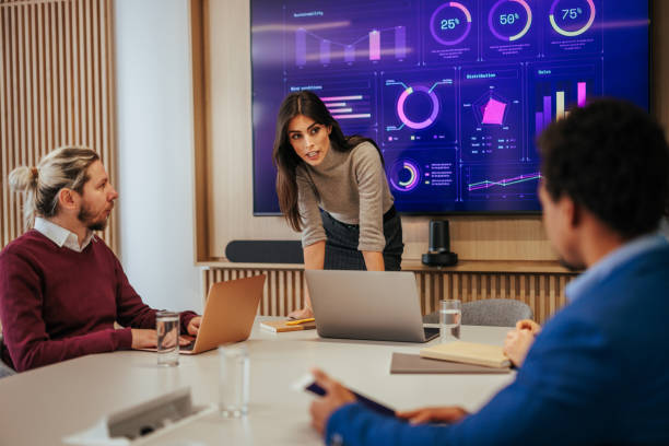 istock Female manager with coworkers in boardroom. 1478372905