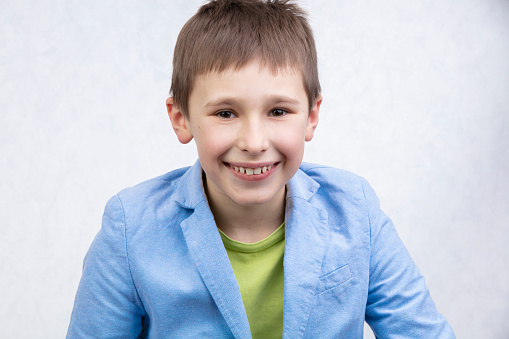 Portrait of young boy in vest, studio
