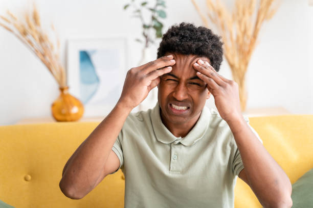 istock Cheerful black man covering eyes, headache 1478374433