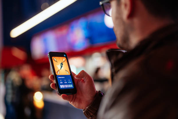 istock Man buying movie tickets with mobile app. 1478374517