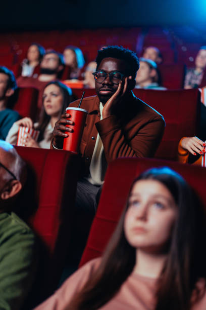 istock Man sleeping in movie theater. 1478374844