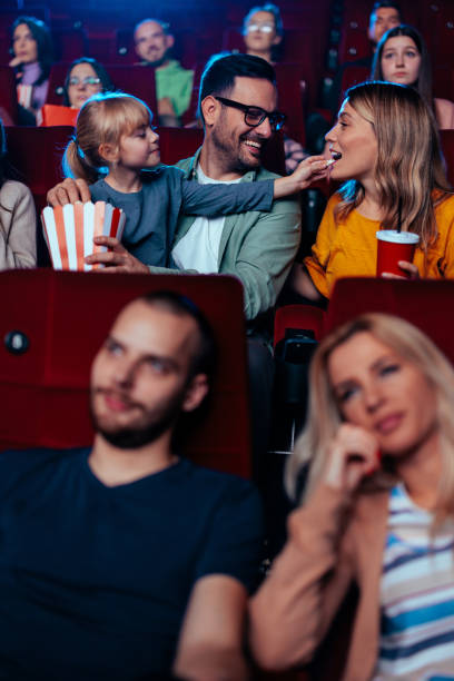 istock Child with parents in cinema. 1478374871