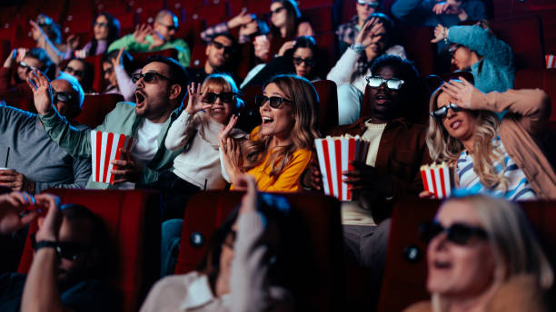 istock Excited audience watching 3Dmovie in theater. 1478374876