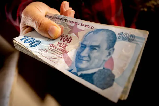 Photo of Hands holding lots of TL banknotes