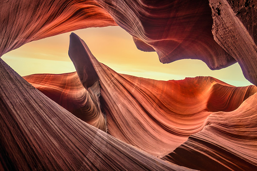 Low angle view from inside the Lower Antelope Slot Canyon in Page with a orange sky, Arizona. USA