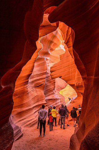 Page, USA - October 13, 2018: A group of tourists walking through the narrow pathways of the lower Antelope Canyon.