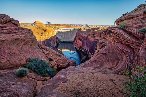 Sunrise at Glen Canyon Dam and Glen Canyon Dam Bridge over Lake Powell, Glen Canyon National Recreation Area, Coconino County, Page, Arizona, USA.