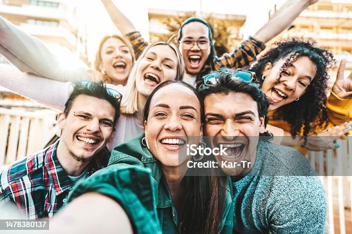 istock Happy multiracial friends taking selfie pic outside - Cheerful young people smiling together at camera - Life style concept with guys and girls hanging out on summer vacation - Bright filter 1478380137