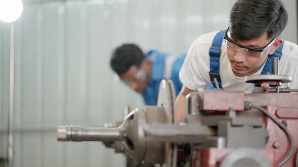 istock Experienced and skill operator. Metalworking industry concept. Professional engineer or metalworker operating milling machine center in manufacturing workshop. Production line worker or technician wearing safety uniform, working in metal factory or heavy 1478380470