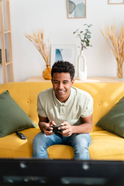 istock Cheerful black man playing videogames 1478380529