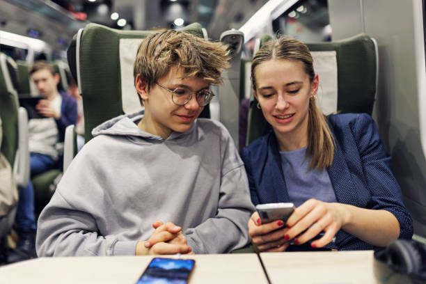 istock Two teenagers travelling on modern train 1478380991