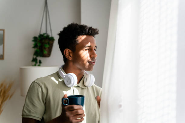 istock Cheerful black man with cup of coffee 1478382542