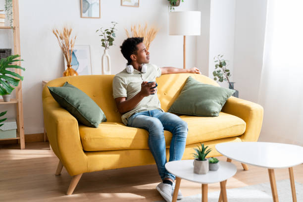 istock Cheerful black man relaxing at home 1478383304