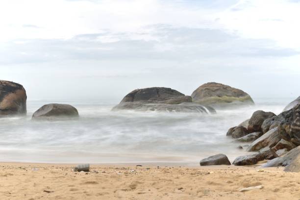 istock Sandy shore of an ocean beach, surrounded by smaller rocks and pebbles 1478384272